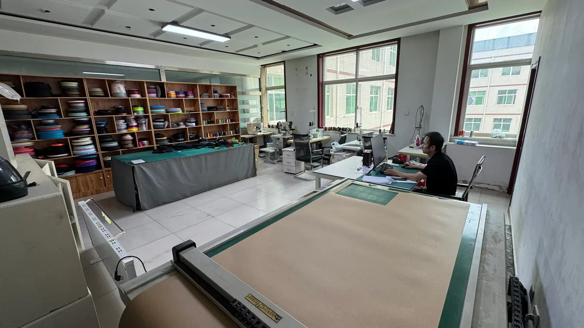 Backpack sample room with cutting table and webbing library